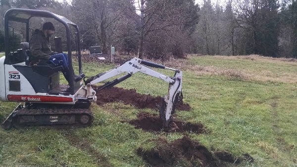 Digging a test hole for soil evaluation.