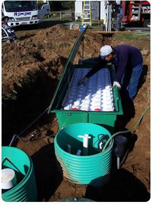 An Advantex AX-20 fabric filter being installed on a site with marginal soils. In this particular case, a drip drainfield was used.