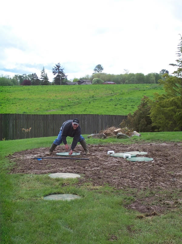 Keith Barto inspecting a Nuwater aerobic system after the tanks were backfilled.