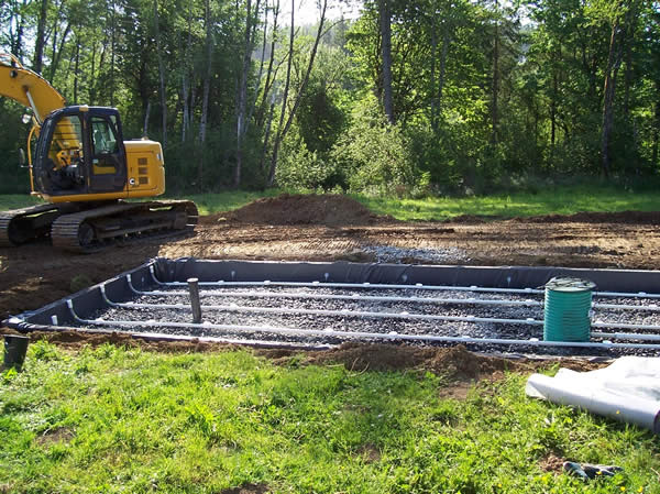A sand filter system installed and prior to backfill. Once completed, there will only be a few lids visible from the surface.