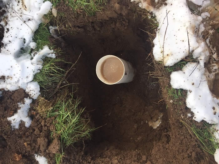 An infiltration test being conducted during a snowy winter day.